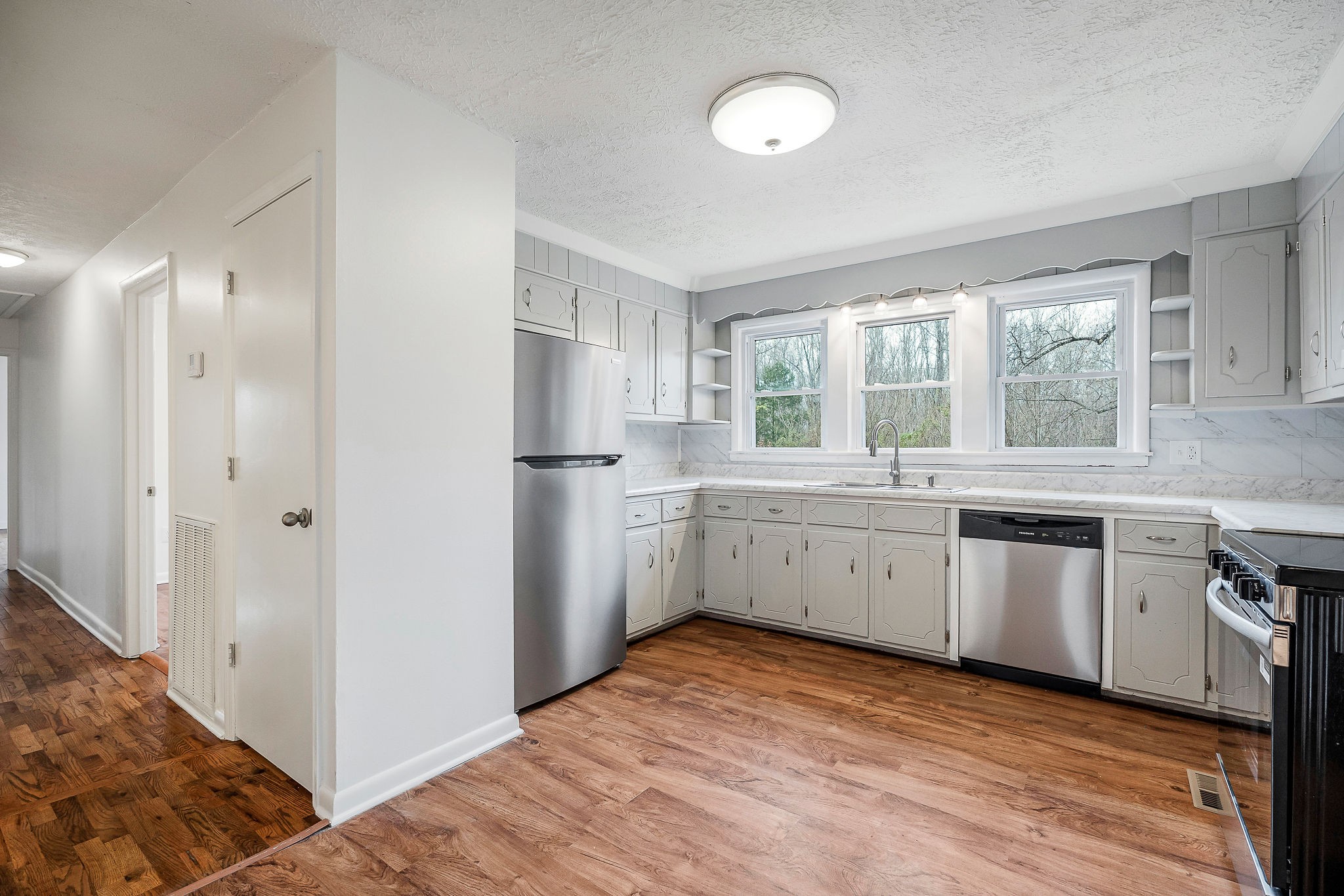 240 Blue Hill Road Woodbury, TN 37190 - Photo 6 of 17 a kitchen with a sink refrigerator and window
