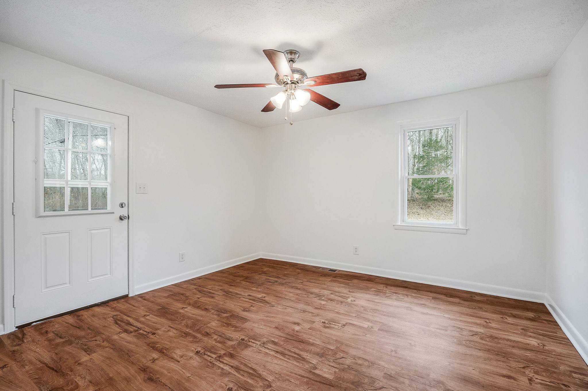 240 Blue Hill Road Woodbury, TN 37190 - Photo 8 of 17 a view of empty room with wooden floor and fan