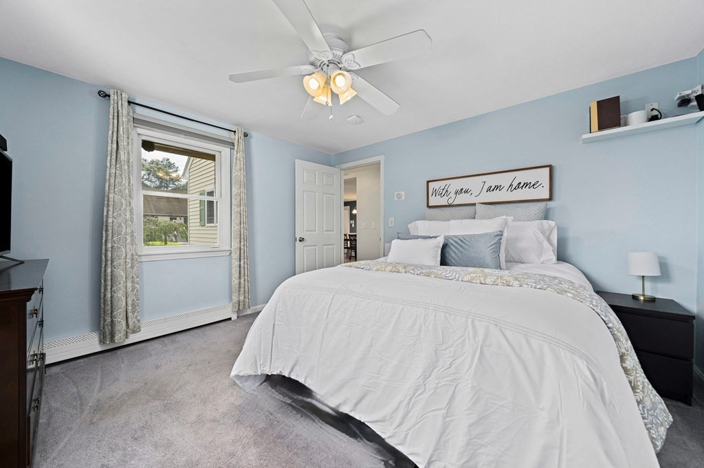 14 Edith Road Weymouth, MA 02189 - Photo 15 of 35 a spacious bedroom with a bed and a chandelier