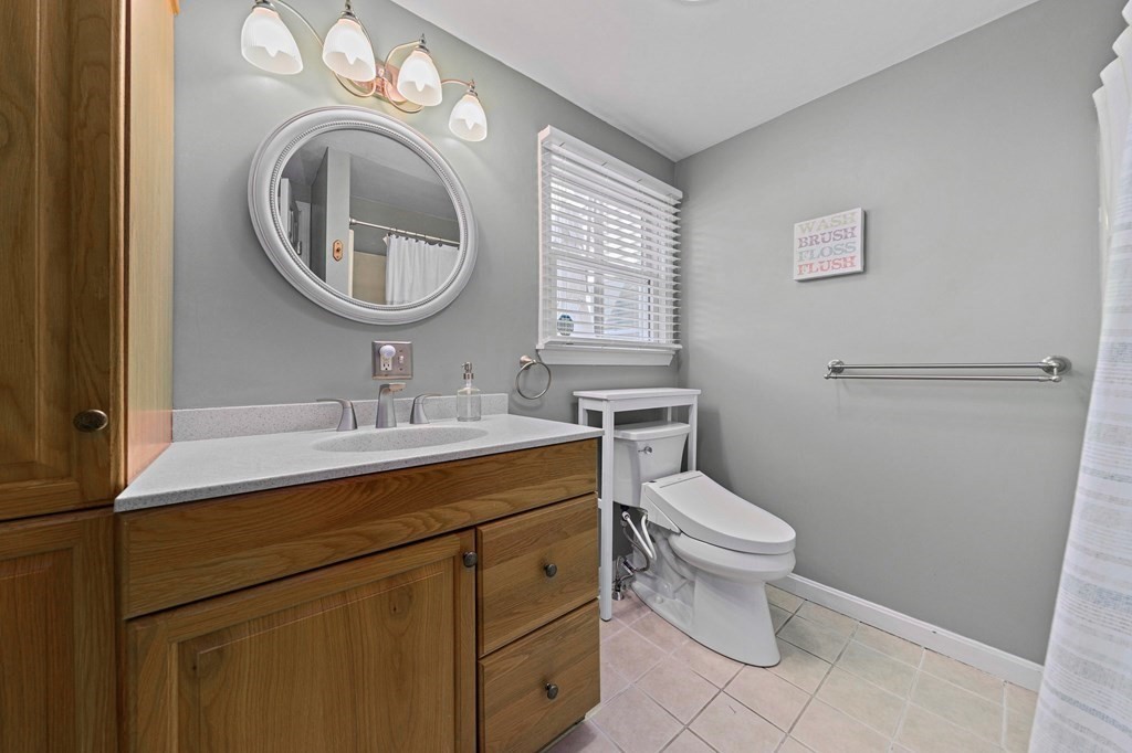 14 Edith Road Weymouth, MA 02189 - Photo 19 of 35 a bathroom with a sink a toilet and a mirror
