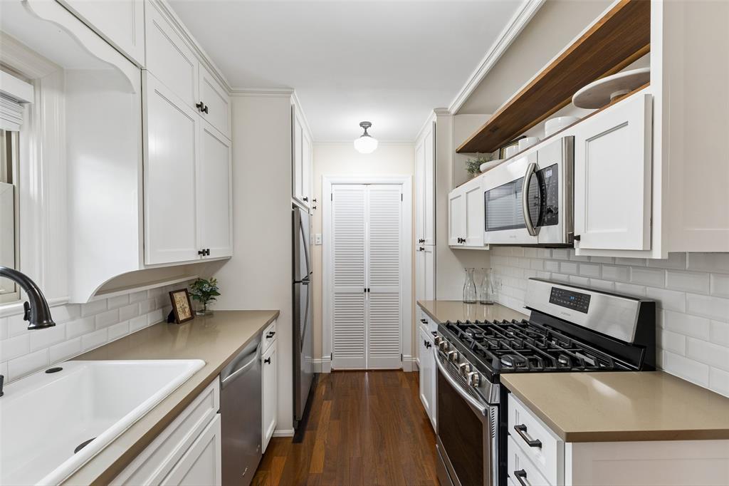 2427 Alco Avenue Dallas, TX 75211 - Photo 6 of 26 a kitchen with a sink stove and refrigerator