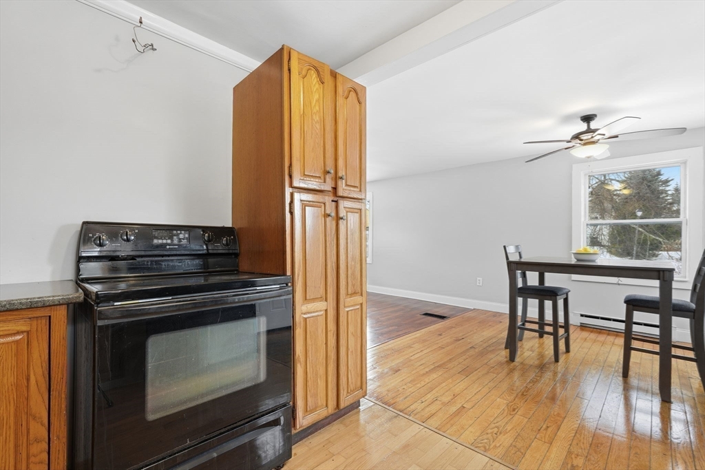 5 Marco Drive Pittsfield, MA 01201 - Photo 13 of 42 a kitchen with a stove and a wooden floor