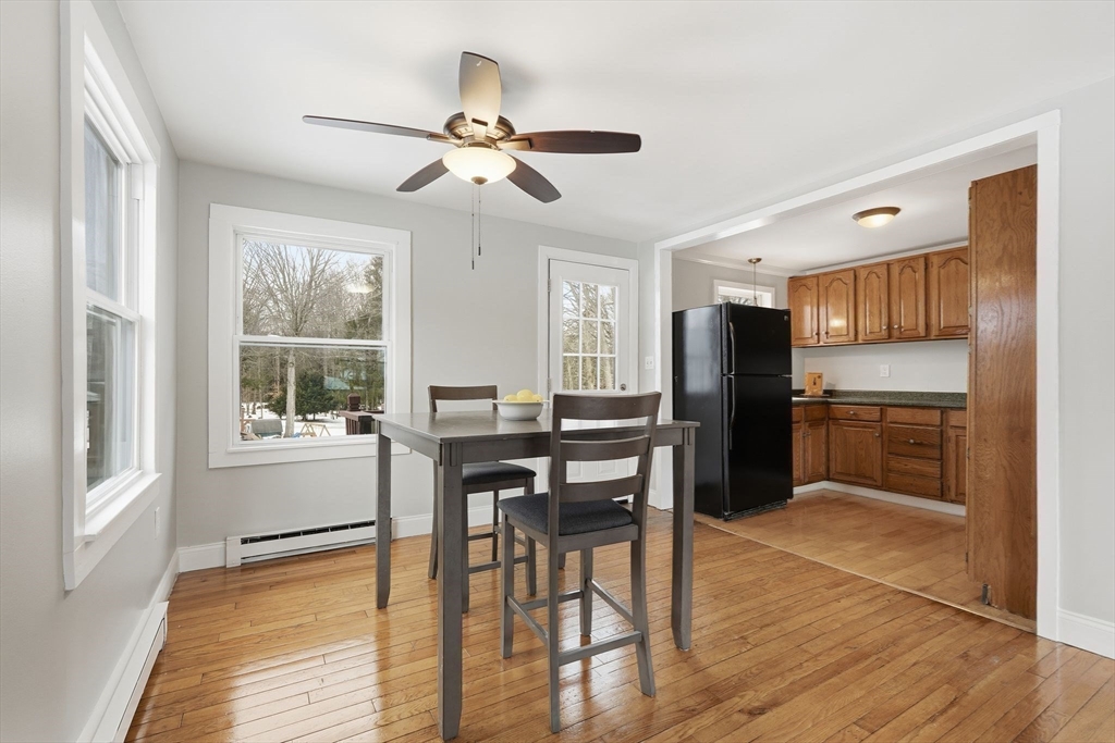 5 Marco Drive Pittsfield, MA 01201 - Photo 17 of 42 a kitchen with stainless steel appliances kitchen island granite countertop a refrigerator a stove a microwave oven with a dining table and chairs with wooden floor
