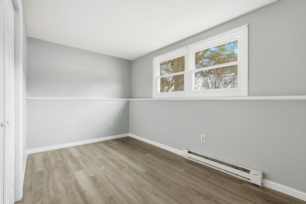 5 Marco Drive Pittsfield, MA 01201 - Photo 24 of 42 an empty room with wooden floor and windows