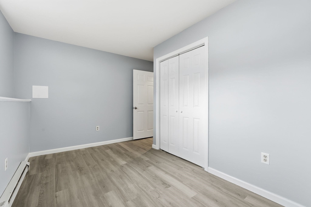 5 Marco Drive Pittsfield, MA 01201 - Photo 25 of 42 a view of an empty room with wooden floor