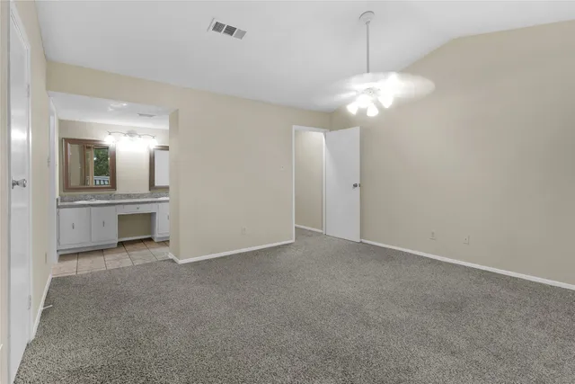 a view of a backyard with plants and large tree