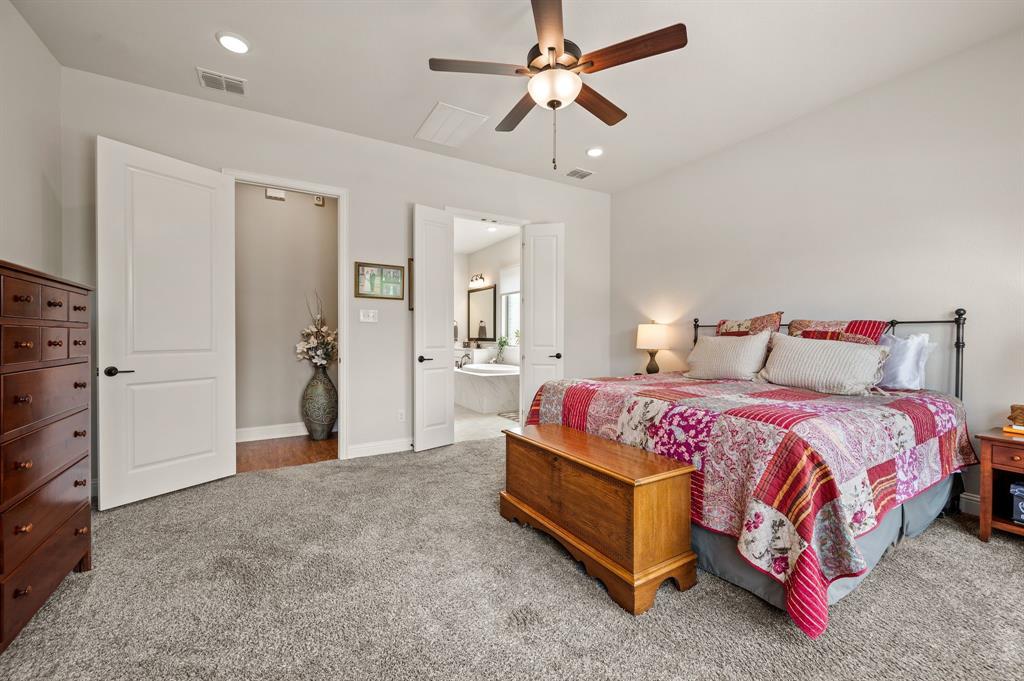 1226 Aster Place Haslet, TX 76052 - Photo 13 of 40 a spacious bedroom with a bed and a dresser
