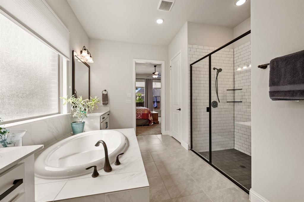 1226 Aster Place Haslet, TX 76052 - Photo 15 of 40 a en suite bathroom with a tub shower and mirror