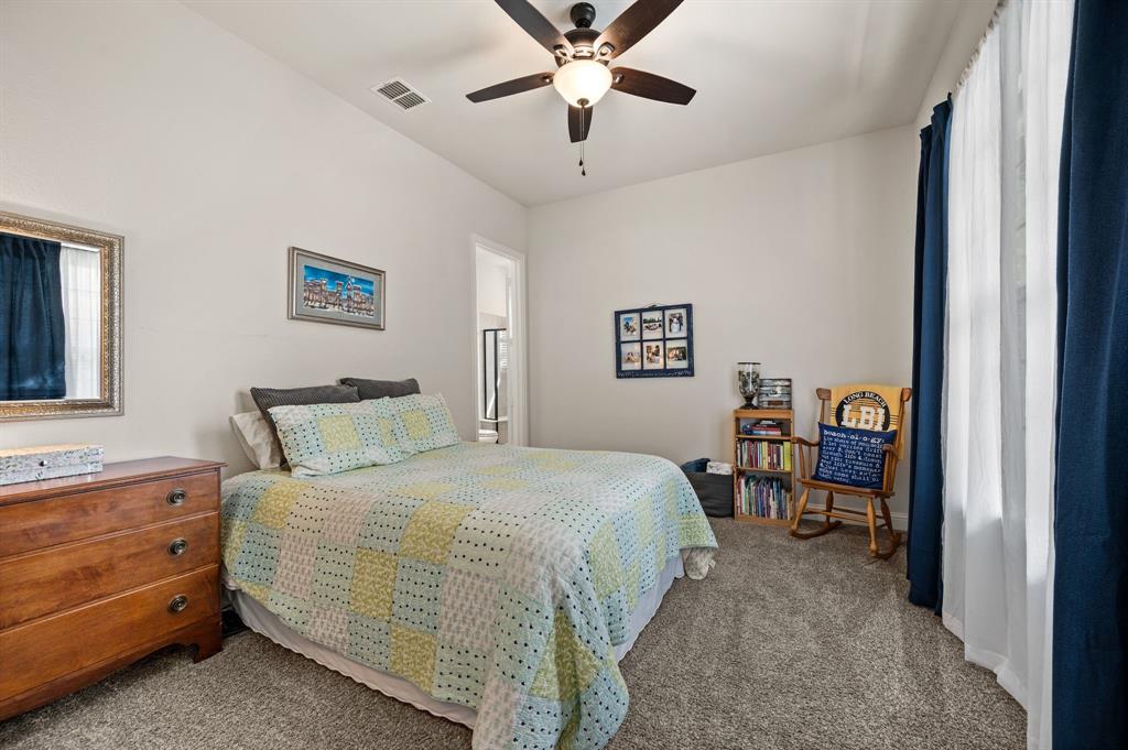 1226 Aster Place Haslet, TX 76052 - Photo 18 of 40 a bedroom with a bed and a chandelier