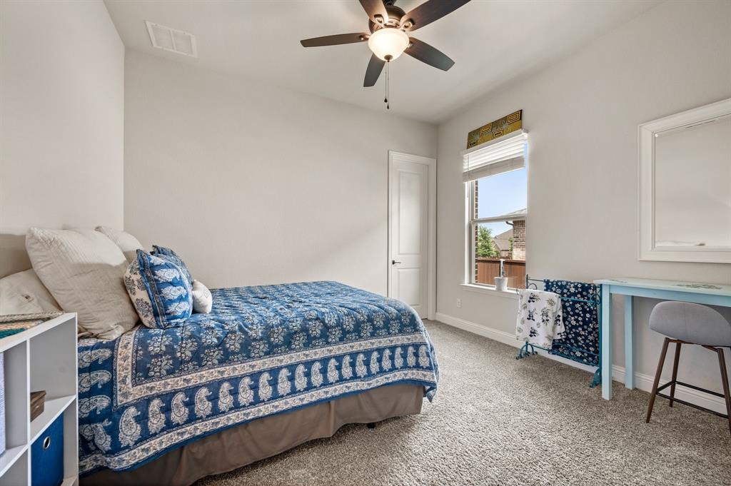 1226 Aster Place Haslet, TX 76052 - Photo 20 of 40 a bedroom with a bed window and a table