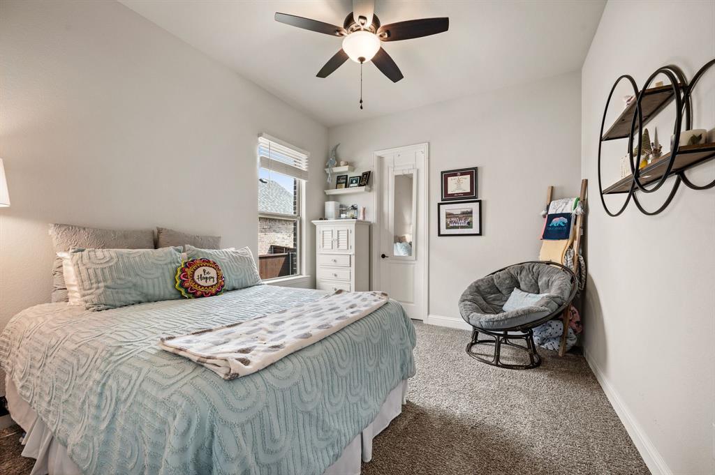 1226 Aster Place Haslet, TX 76052 - Photo 22 of 40 a bedroom with a bed and a chandelier