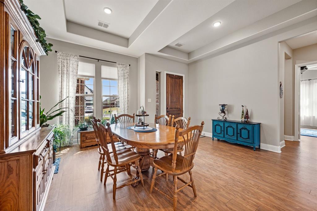 1226 Aster Place Haslet, TX 76052 - Photo 4 of 40 a view of a dining room with furniture and wooden floor