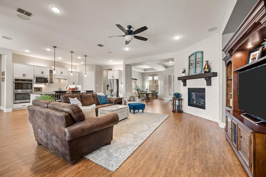 1226 Aster Place Haslet, TX 76052 - Photo 40 of 40 a living room with furniture a flat screen tv and a fireplace