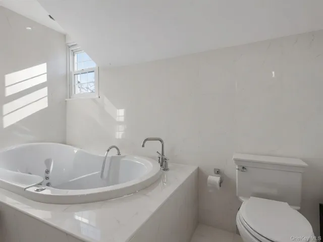 a bathroom with a toilet a sink and bathtub