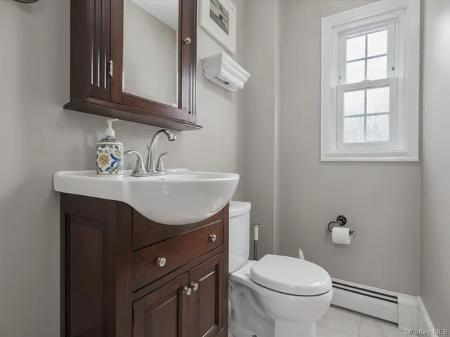 a bathroom with a sink toilet and vanity