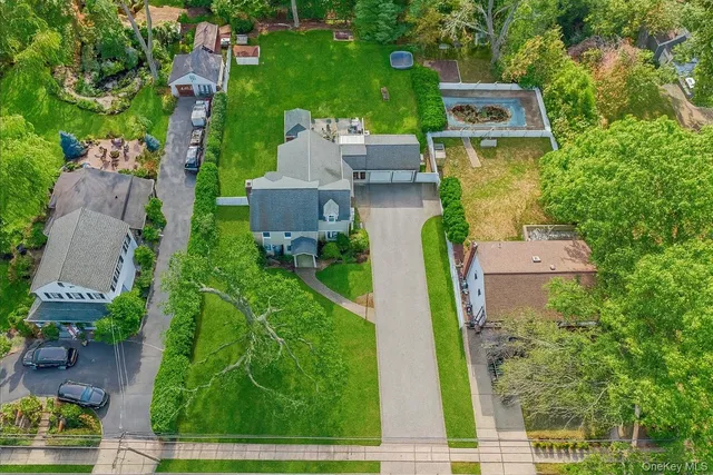 an aerial view of a house with garden space and street view