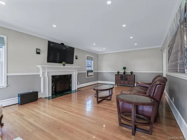 a living room with furniture a fireplace and a flat screen tv
