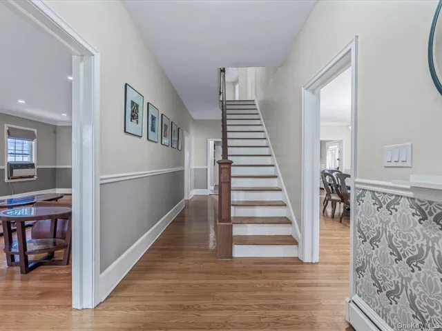 a view of a hallway with wooden floor and entryway