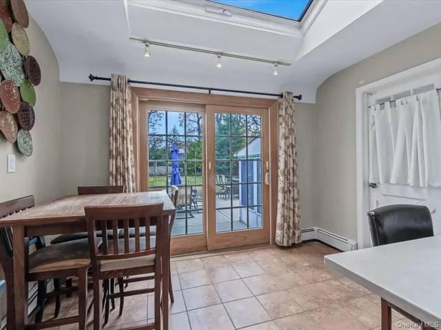 a dining room with furniture and window