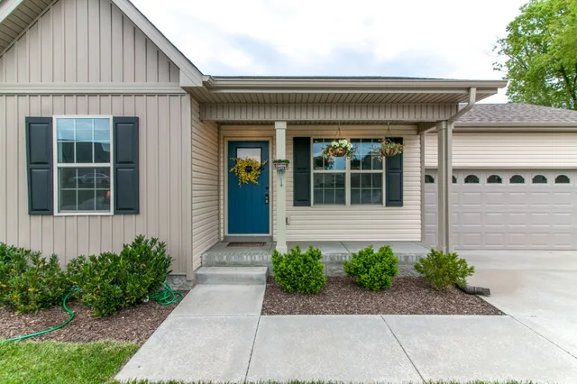 a view of a house with potted plants