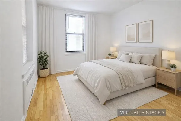 a spacious bedroom with a bed and a window