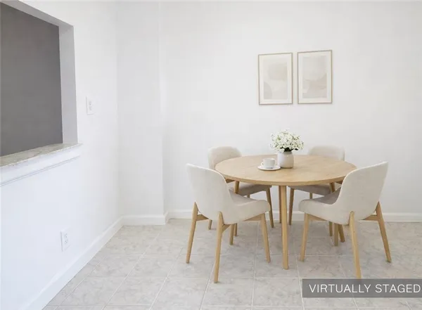 a dining room with furniture and a potted plant