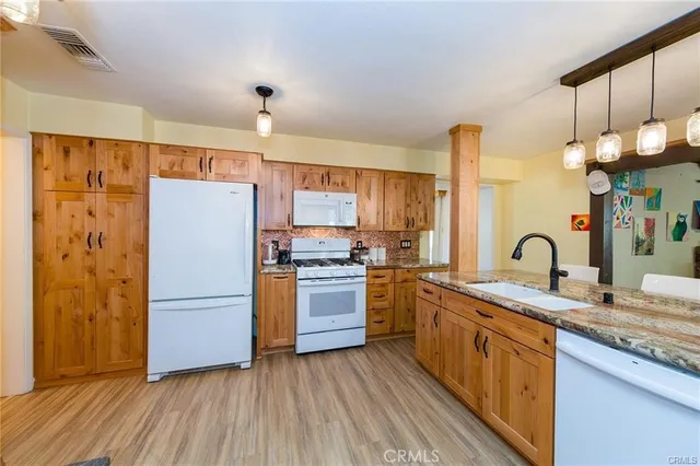 a kitchen with a refrigerator and a sink