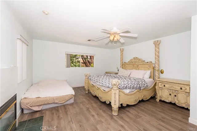 a room with a bed chandelier and a window