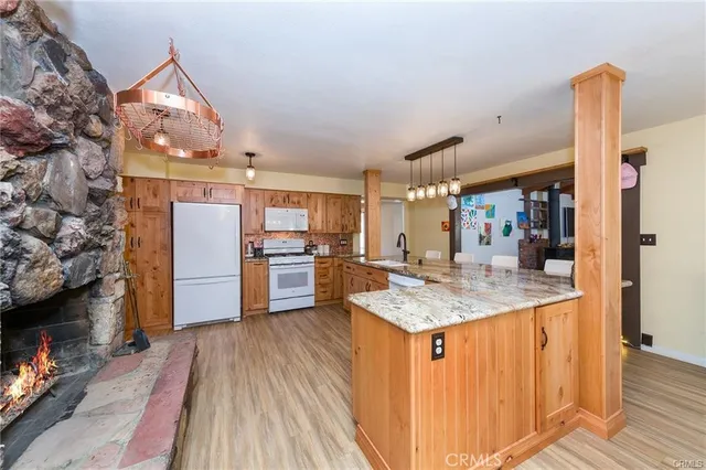 a kitchen with stainless steel appliances granite countertop a sink refrigerator and cabinets