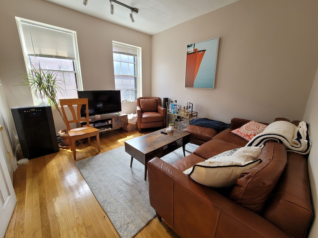 11 Phillips Street, Unit 8 Boston, MA 02114 - Photo 3 of 14 a living room with furniture and a fireplace