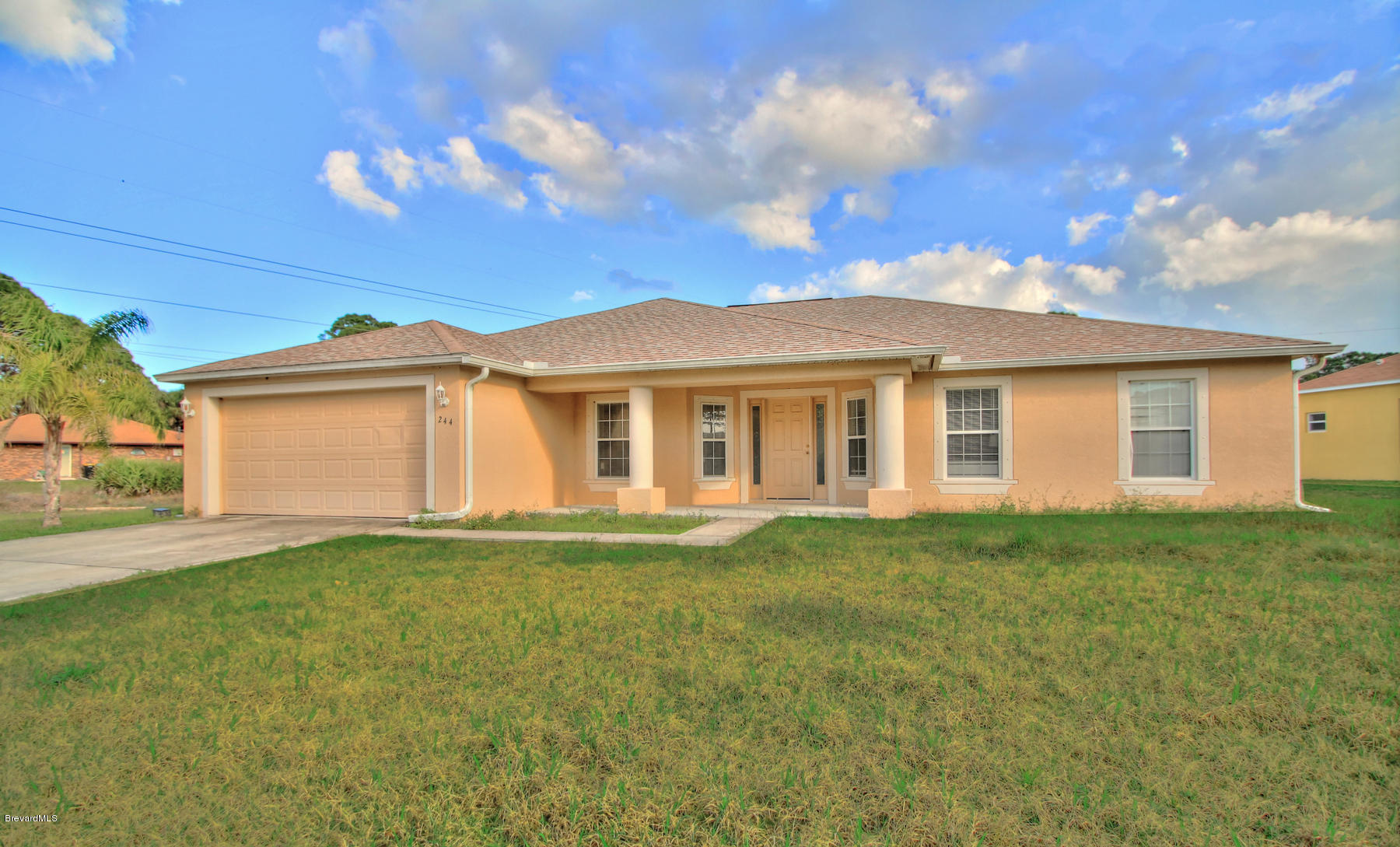 244 Abello Road Southeast Palm Bay, FL 32909 - Photo 2 of 23 a view of a yard in front of a house with a large tree