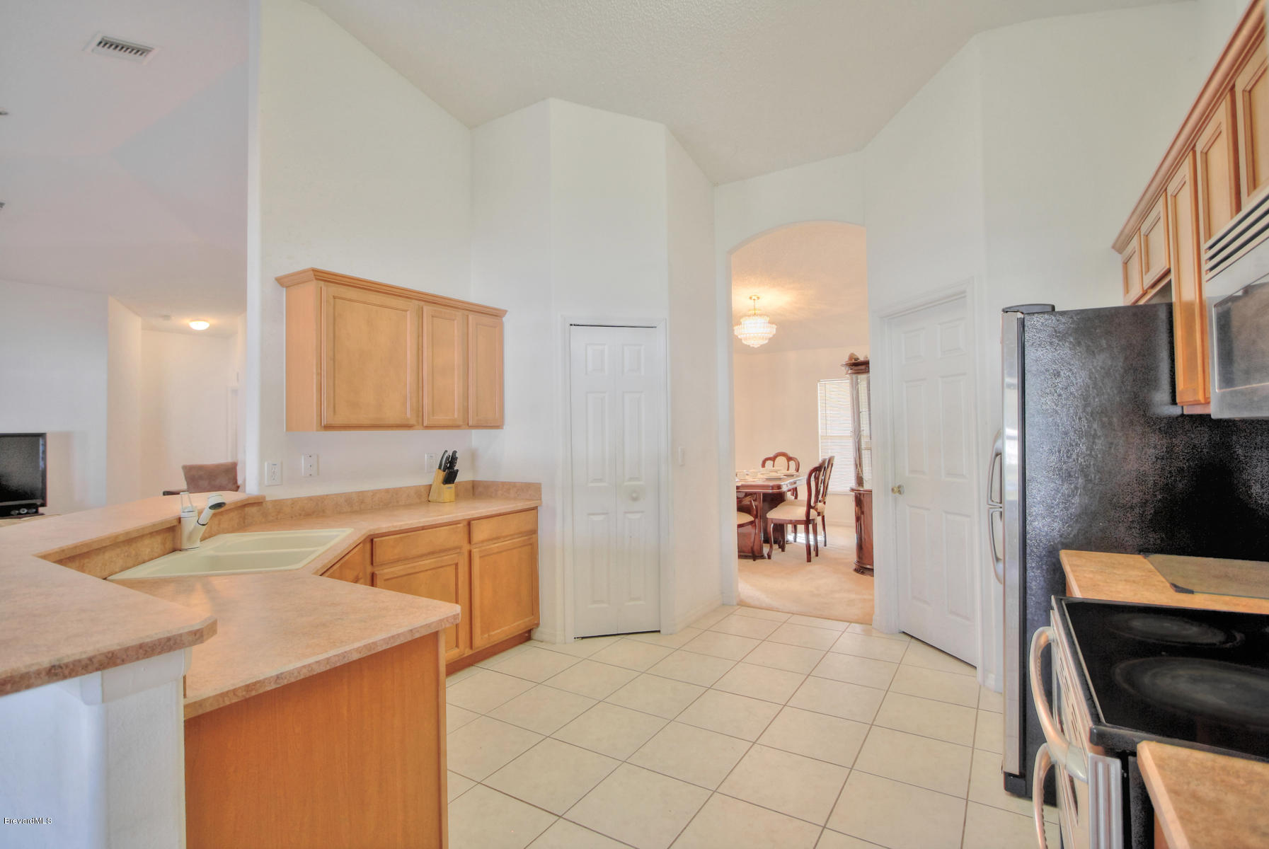 244 Abello Road Southeast Palm Bay, FL 32909 - Photo 11 of 23 a large white kitchen with a sink and dishwasher a refrigerator with white cabinets