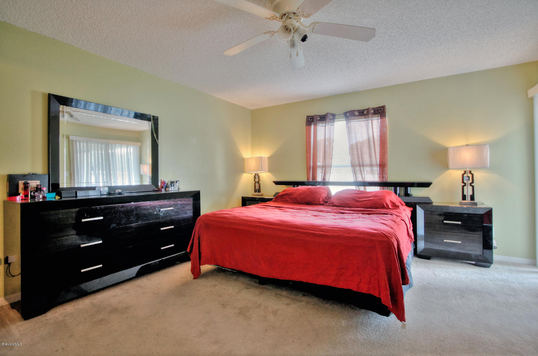 244 Abello Road Southeast Palm Bay, FL 32909 - Photo 14 of 23 a bedroom with a bed and a mirror on dresser