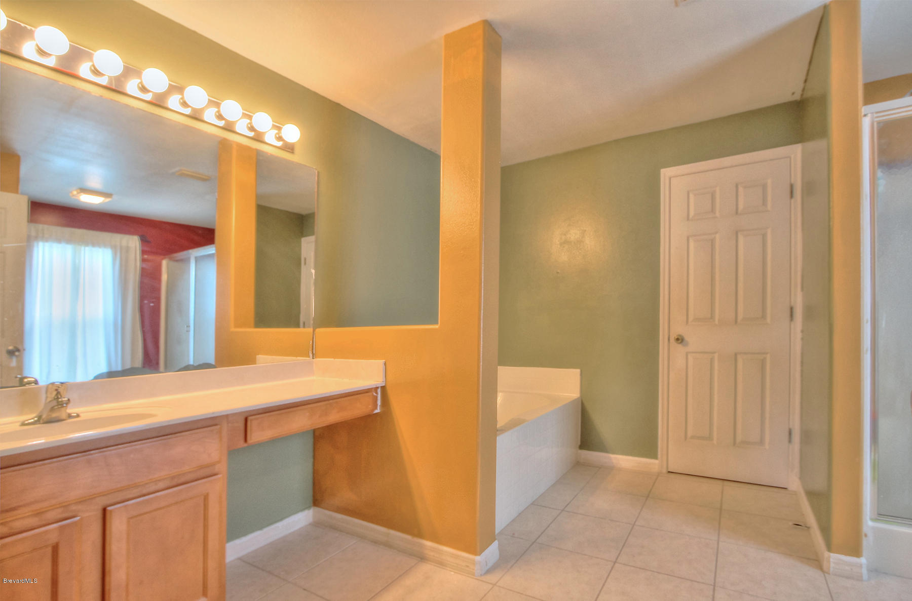 244 Abello Road Southeast Palm Bay, FL 32909 - Photo 15 of 23 a bathroom with a sink a vanity and a mirror