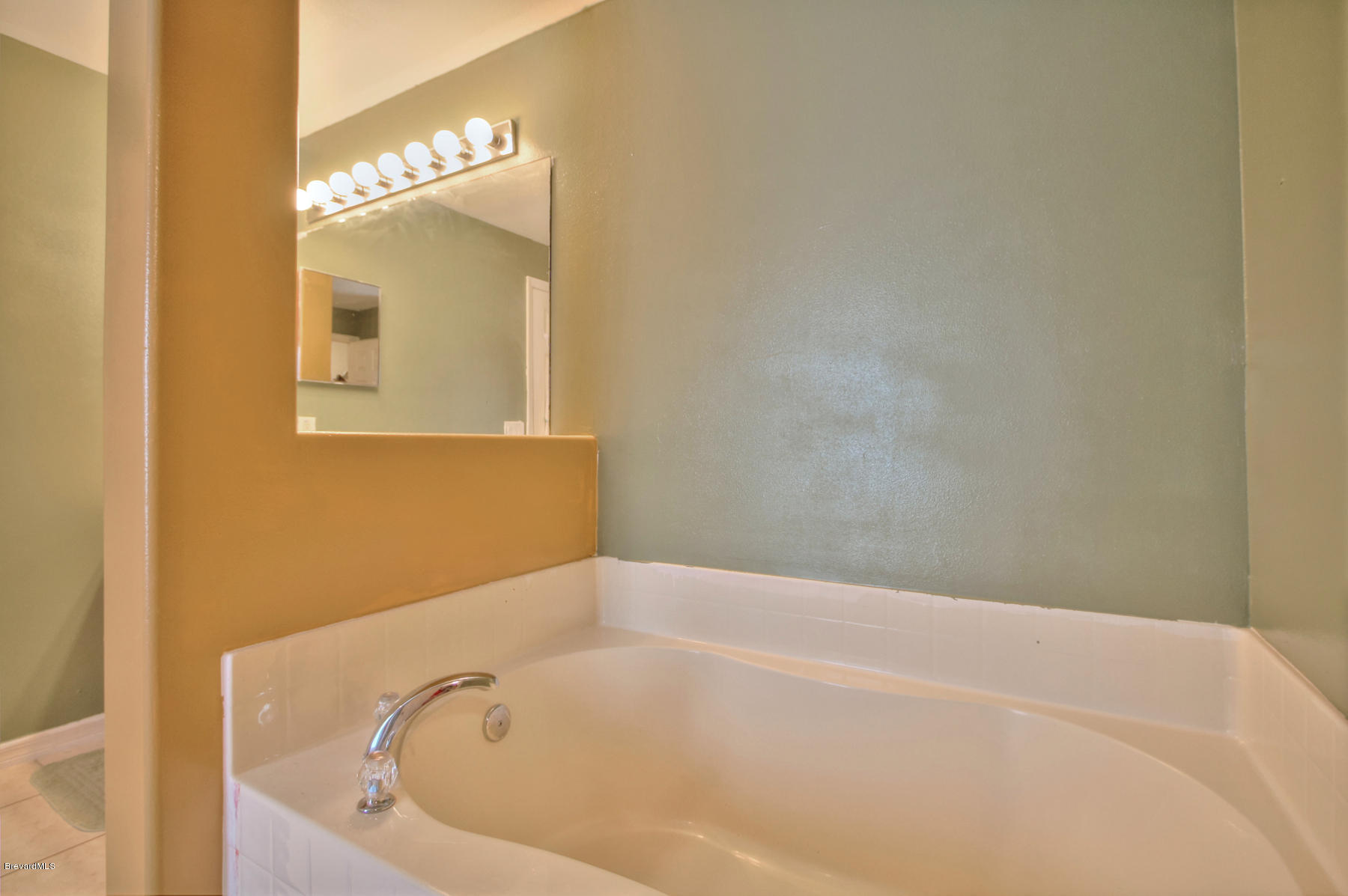 244 Abello Road Southeast Palm Bay, FL 32909 - Photo 16 of 23 a white bath tub sitting in a bathroom