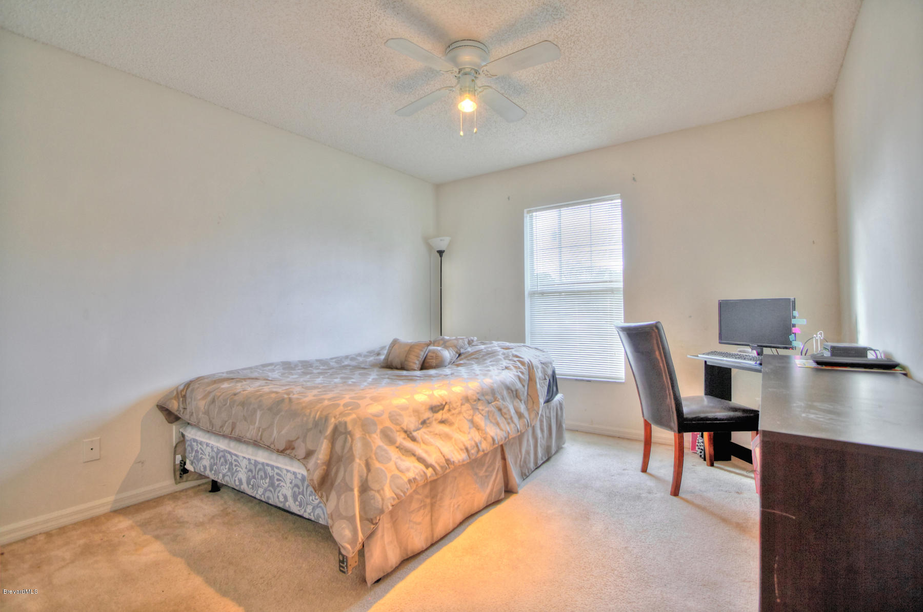 244 Abello Road Southeast Palm Bay, FL 32909 - Photo 19 of 23 a bedroom with a bed and a chandelier