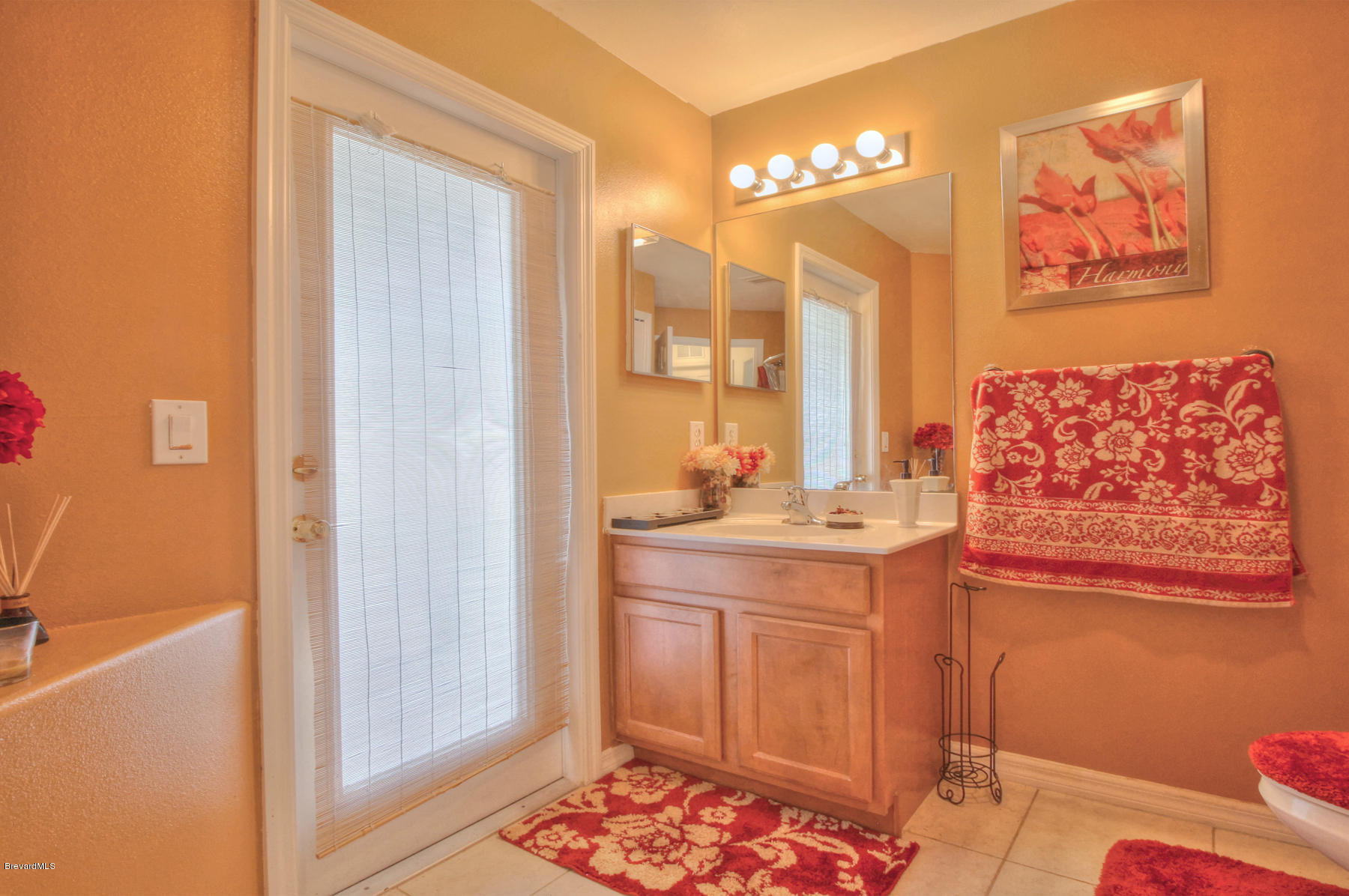 244 Abello Road Southeast Palm Bay, FL 32909 - Photo 20 of 23 a bathroom with a double vanity sink and a mirror