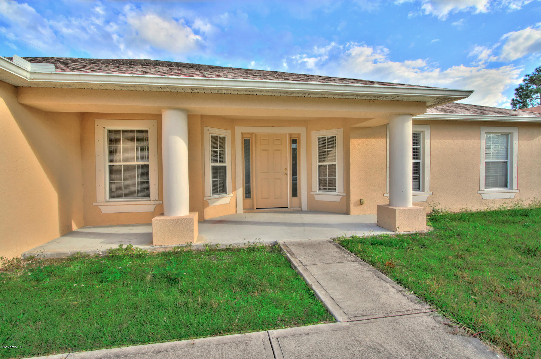 244 Abello Road Southeast Palm Bay, FL 32909 - Photo 3 of 23 front view of a house with a yard