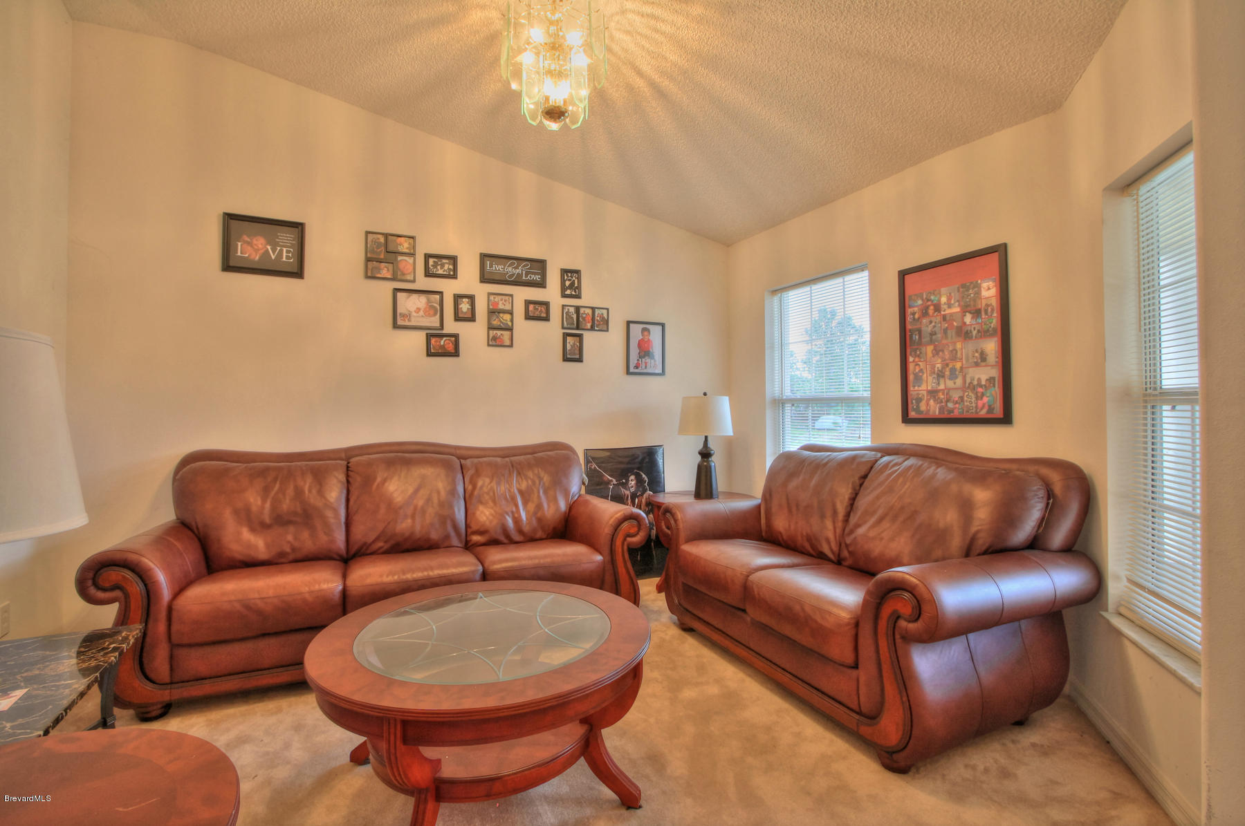 244 Abello Road Southeast Palm Bay, FL 32909 - Photo 6 of 23 a blue couch sitting in a living room with furniture