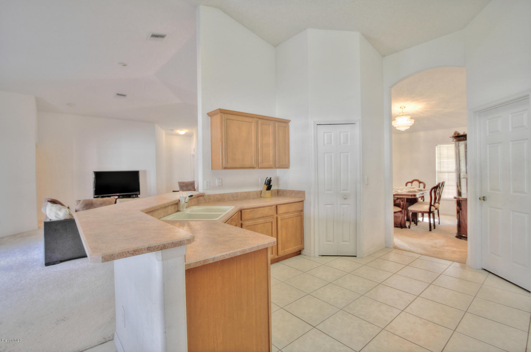 244 Abello Road Southeast Palm Bay, FL 32909 - Photo 9 of 23 a living room with stainless steel appliances kitchen island granite countertop a sink a stove a dining table and chairs