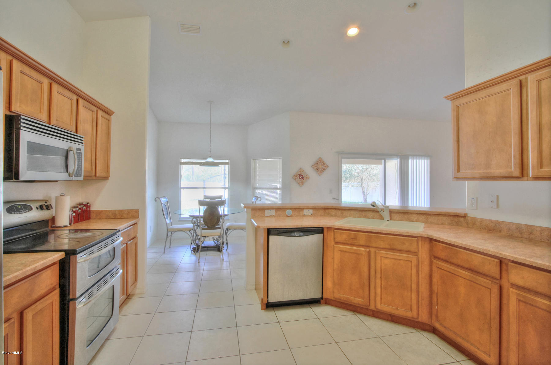 244 Abello Road Southeast Palm Bay, FL 32909 - Photo 10 of 23 a kitchen with a sink stove and cabinets