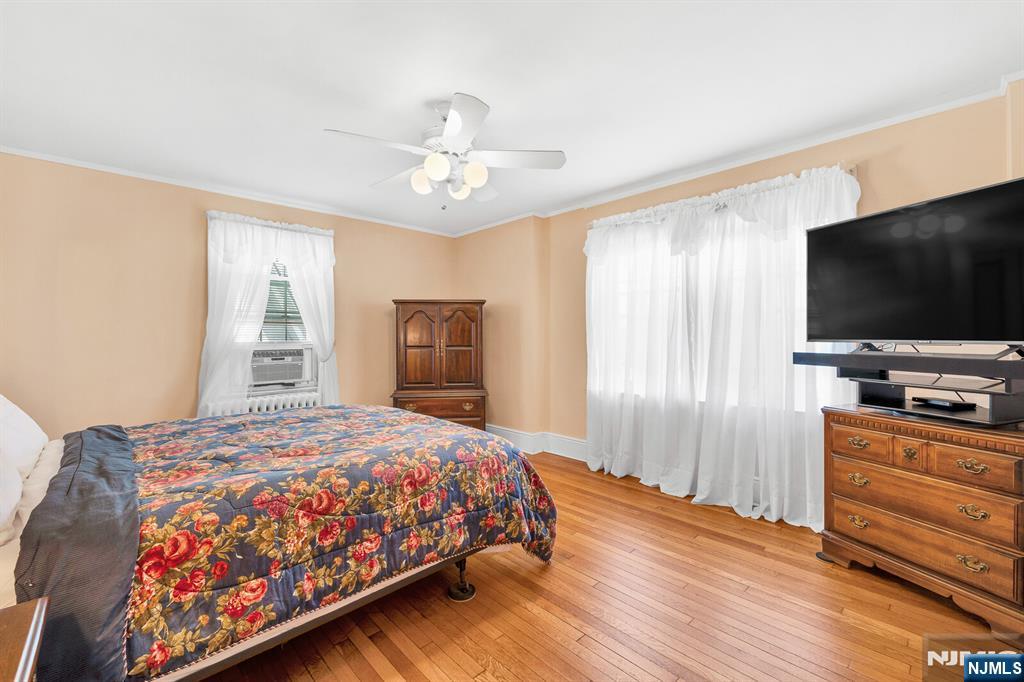 106 Maple Street Rutherford, NJ 07070 - Photo 28 of 50 a bedroom with a bed and a flat screen tv