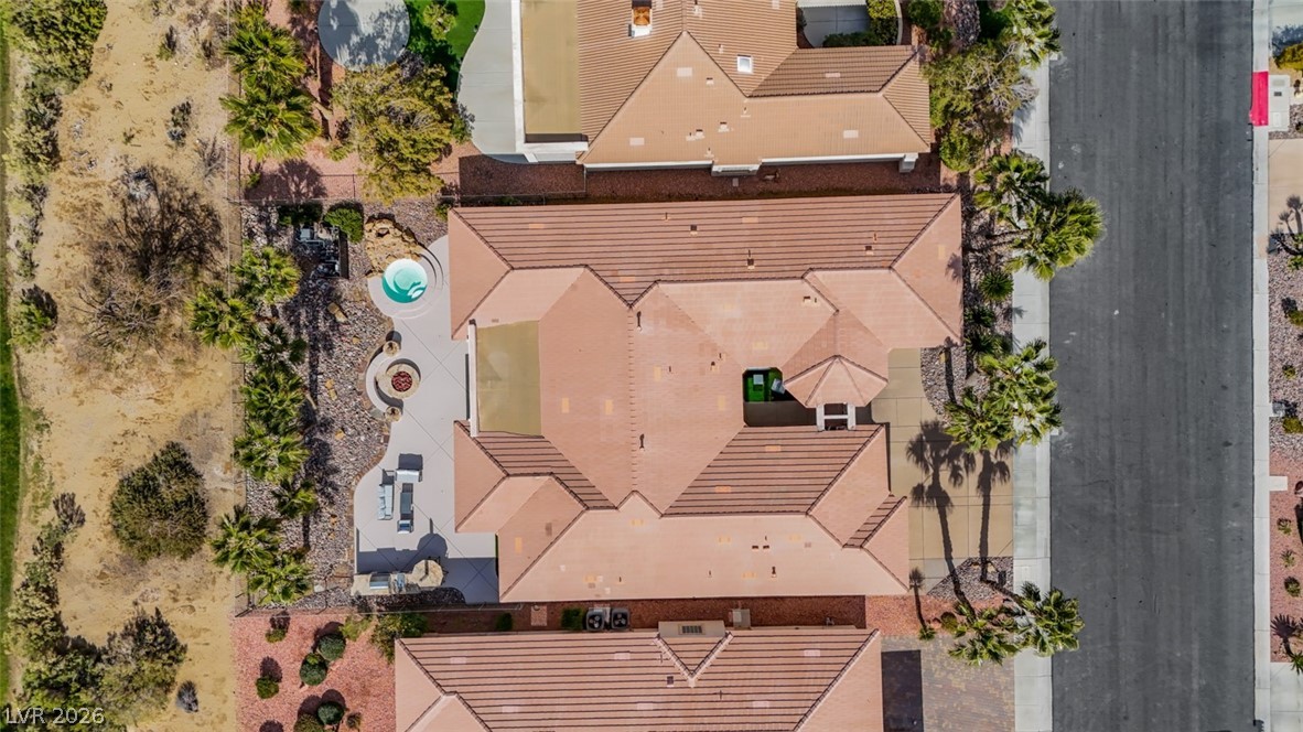 5015 Rivedro Street Las Vegas, NV 89135 - Photo 89 of 91 An aerial perspective reveals a private spa and fire pit nestled amidst desert-inspired landscaping.