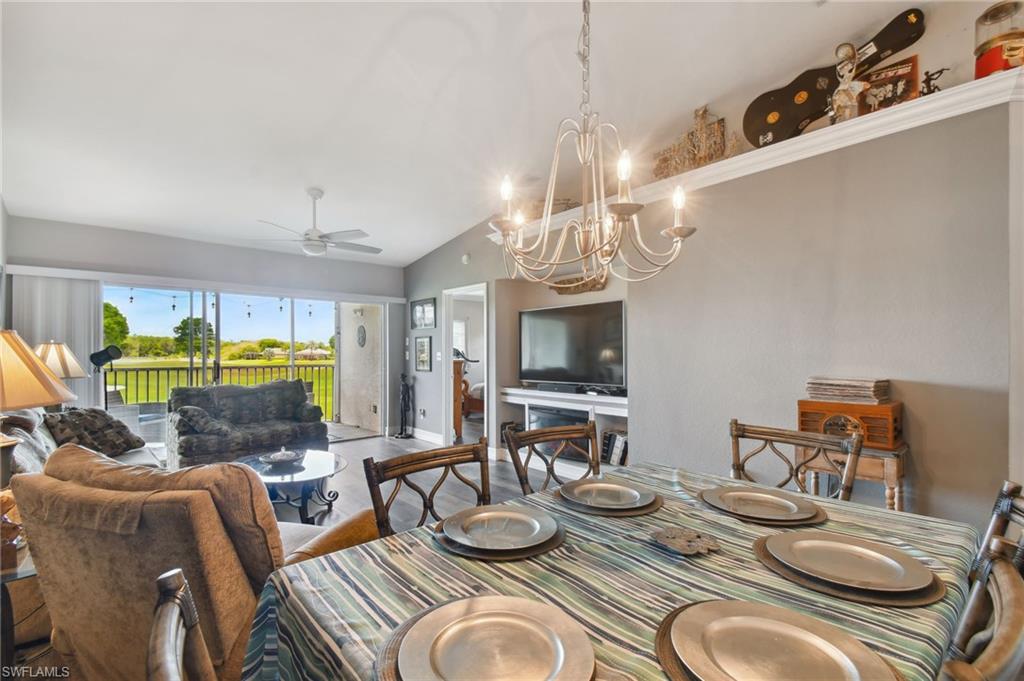 9165 Michael Circle, Unit 1002 Naples, FL 34113 - Photo 13 of 39 a outdoor dining room with furniture a chandelier and window