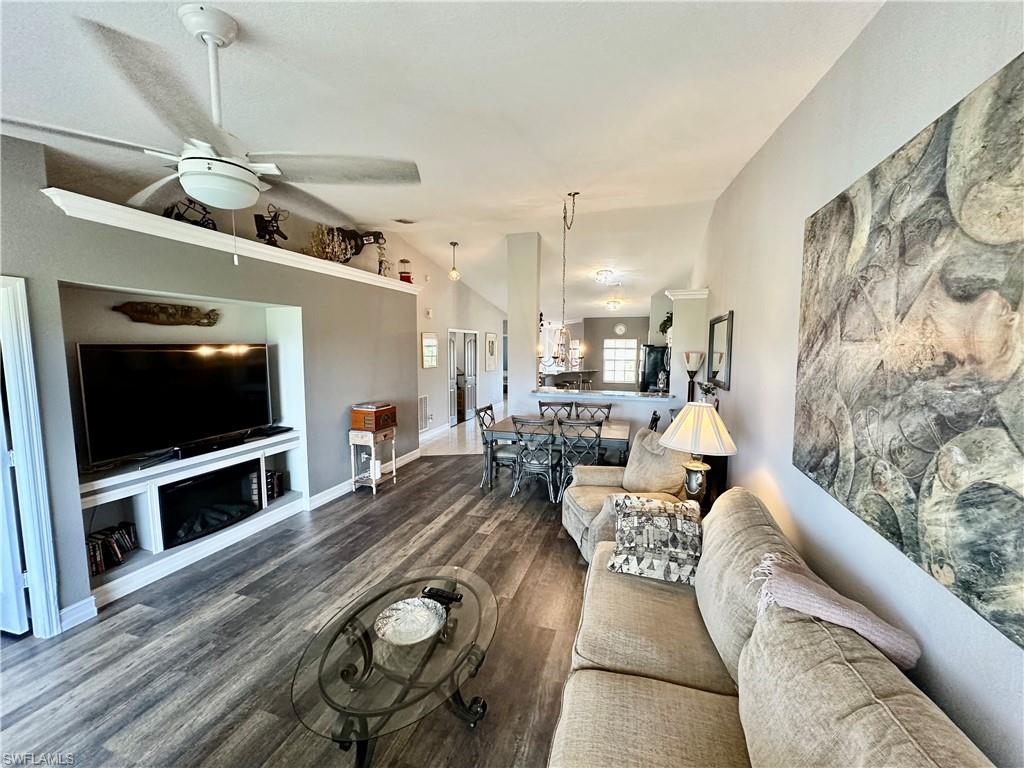 9165 Michael Circle, Unit 1002 Naples, FL 34113 - Photo 17 of 39 a living room with furniture and a flat screen tv