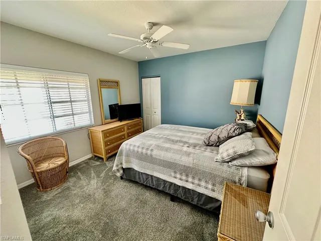 a bedroom with a bed chair and window