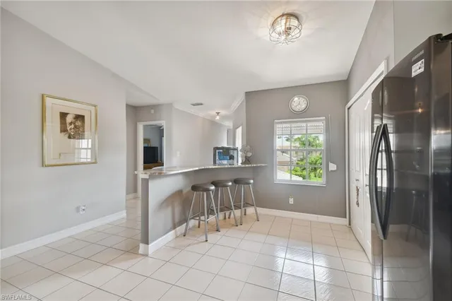 a view of kitchen with furniture and refrigerator