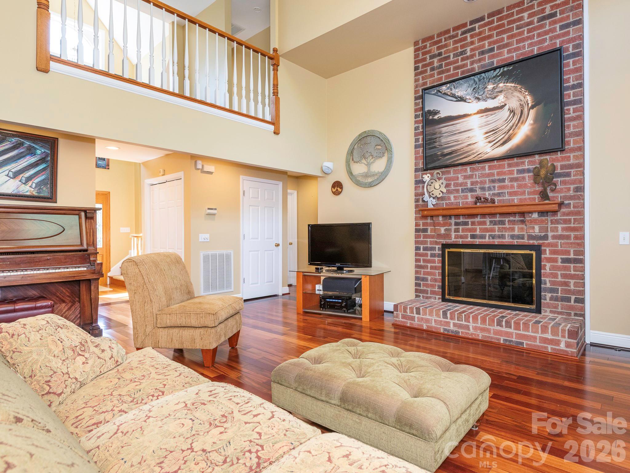4440 Hucks Road Charlotte, NC 28269 - Photo 5 of 45 a living room with furniture a flat screen tv and a fireplace