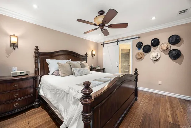 a bedroom with bed and wooden floor