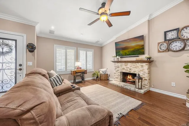 a living room with furniture a flat screen tv and a fireplace